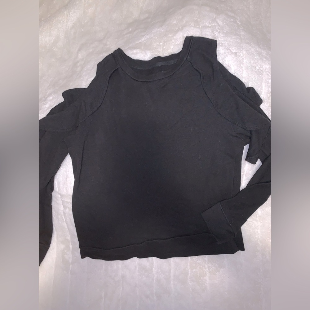 Open shoulder black sweater.